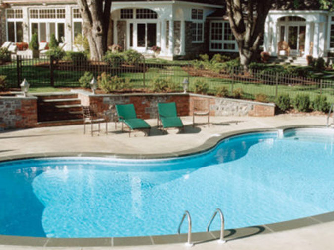 Private backyard kidney shaped swimming pool